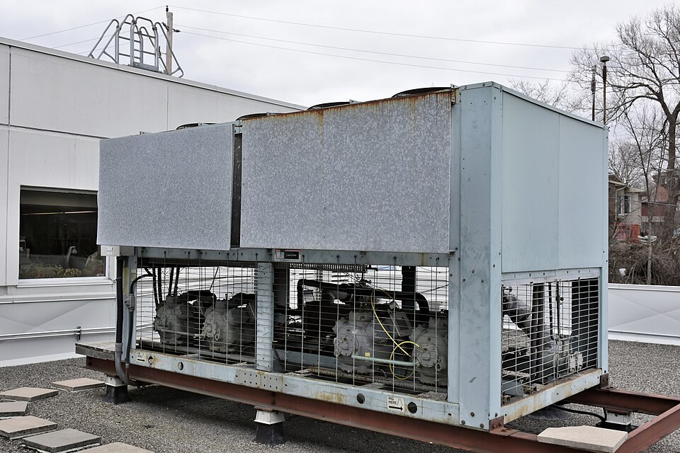 A liquid (glycol-based) chiller with an air-cooled condenser on the roof of a medium size commercial building