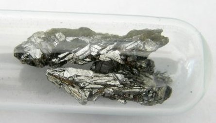 Gray arsenic in a tube.