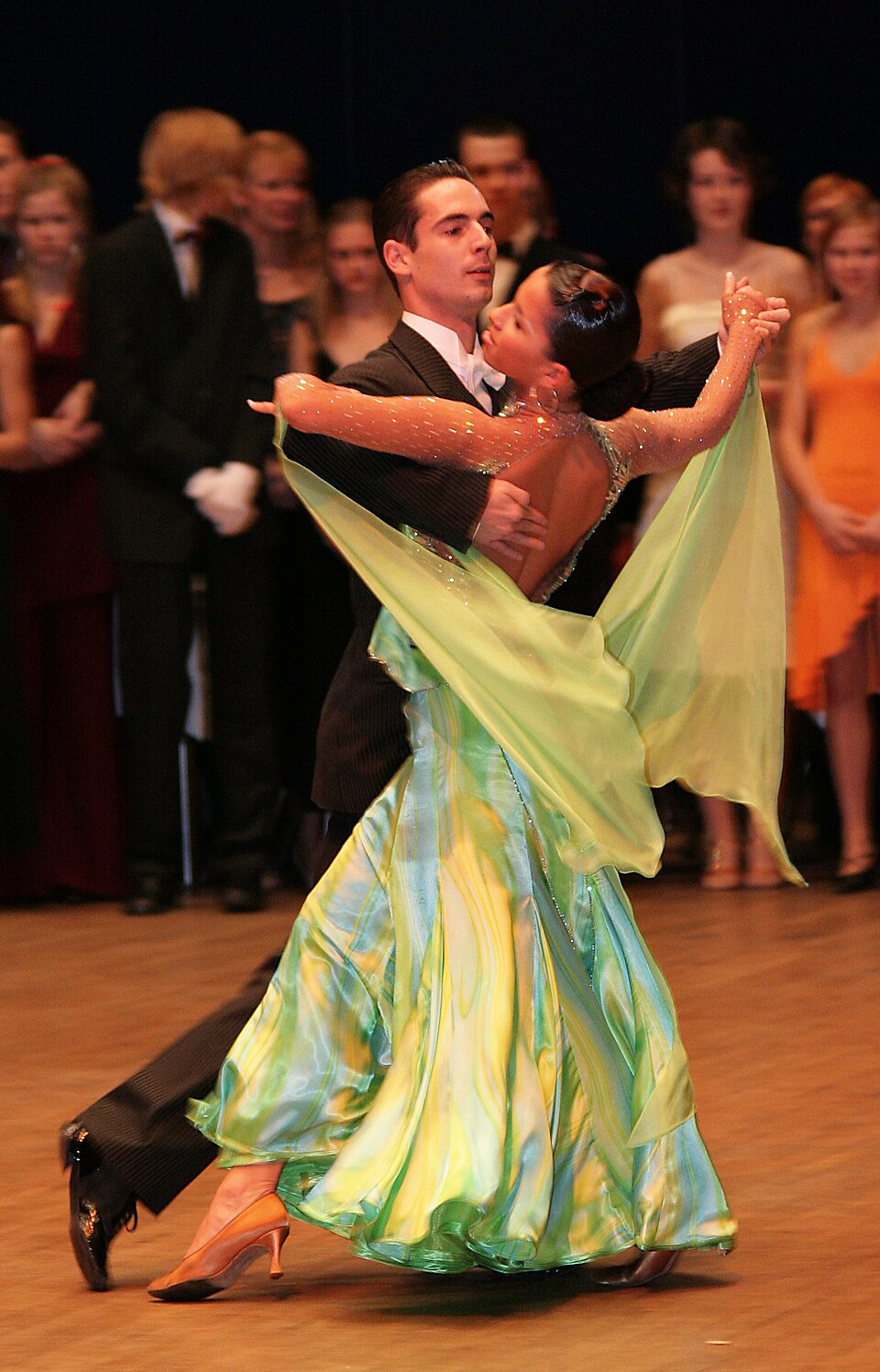 This is a ballroom tango. The style of ballroom dancing is "One big idea: two people dancing as one"