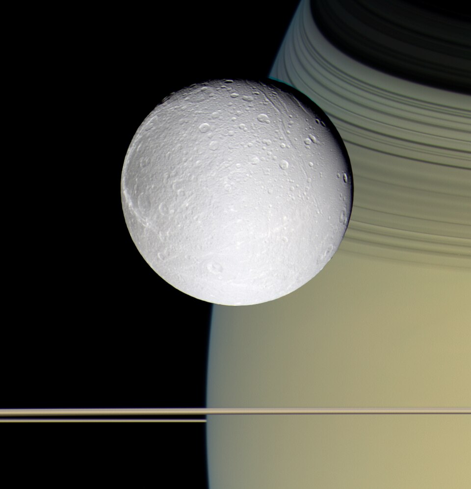 Dione in front of Saturn's rings.