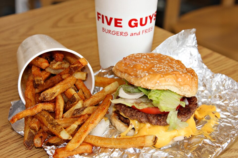 A burger from Five Guys , a burger chain from the U.S. Also shows a common side to hamburgers, french fries.