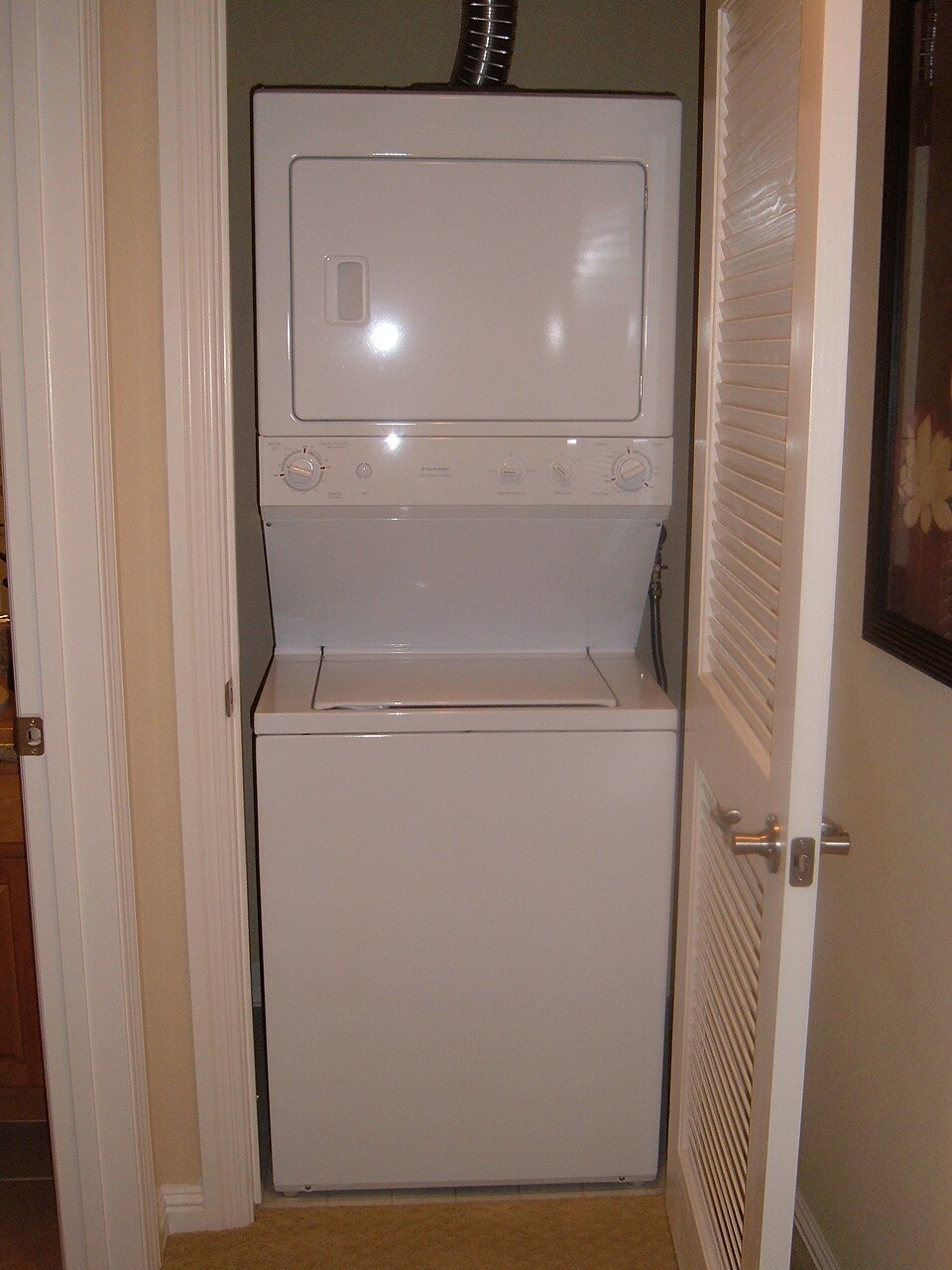 An example of a stacked arrangement: a top loading washing machine and clothes dryer.