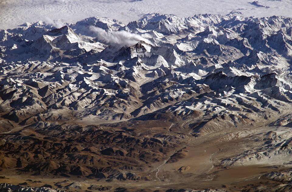 Himalayas from the International Space Station, looking south from over the Tibetan Plateau. The summits are Makalu [left (8,462 metres; 27,765 feet)], Everest [middle (8,848 metres; 29,035 feet)], Lhotse [middle (8,516 metres; 27,939 feet)] and Cho Oyu right (8,201 metres; 26,906 feet)