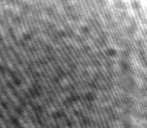 Close-up photograph of a hologram's surface. This is a hologram of a toy car.