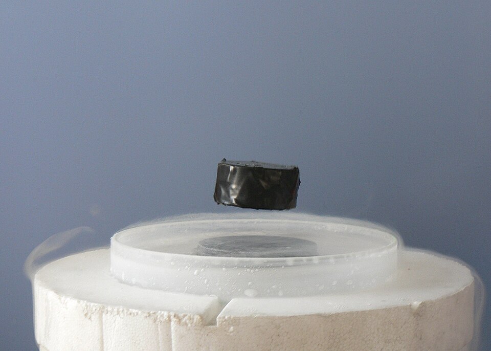 A magnet levitating above a high-temperature superconductor, cooled with liquid nitrogen. Persistent electric current flows on the surface of the superconductor. This excludes the magnetic field of the magnet (Faraday's law of induction). In effect, the current forms an electromagnet that repels the magnet