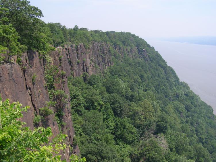 The Palisades Sill as seen from the Palisades Interstate Parkway. The Hudson River is the background. The formation was caused by the rifting of Pangaea in the Triassic