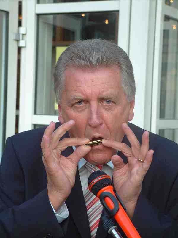 German minister Ernst Pfister playing the smallest harmonica in the world