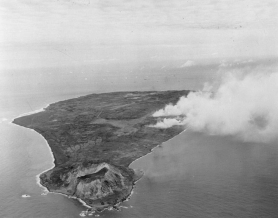 The battle begins with ships firing at the island