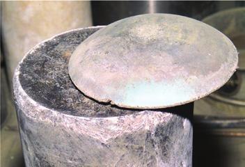 A button of plutonium above a calcium chloride salt cake.