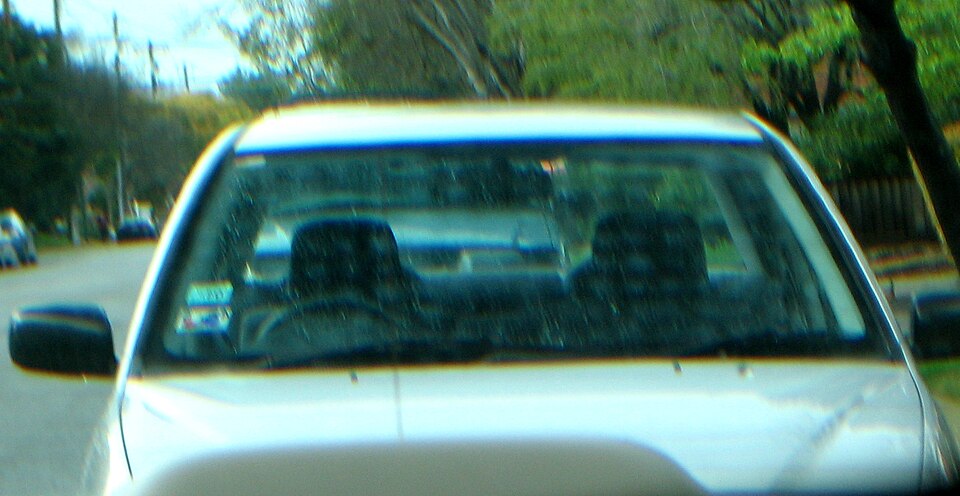 Polarizing sunglasses reveal stress in car window.