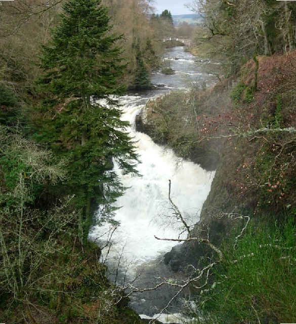 Reekie Linn ('smoking pool'): clouds of spray rise above the plunge pool when the River Isla is in spate. It is a waterfall formed on the Highland Boundary Fault where hard metamorphic rocks to the north give way to the softer sedimentary rocks of Strathmore. This view is taken looking upriver towards the Bridge of Craigisla.