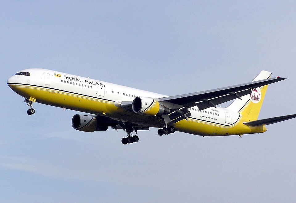 A commercial airplane landing. The flaps on the trailing edge of the wing are fully extended in landing position.