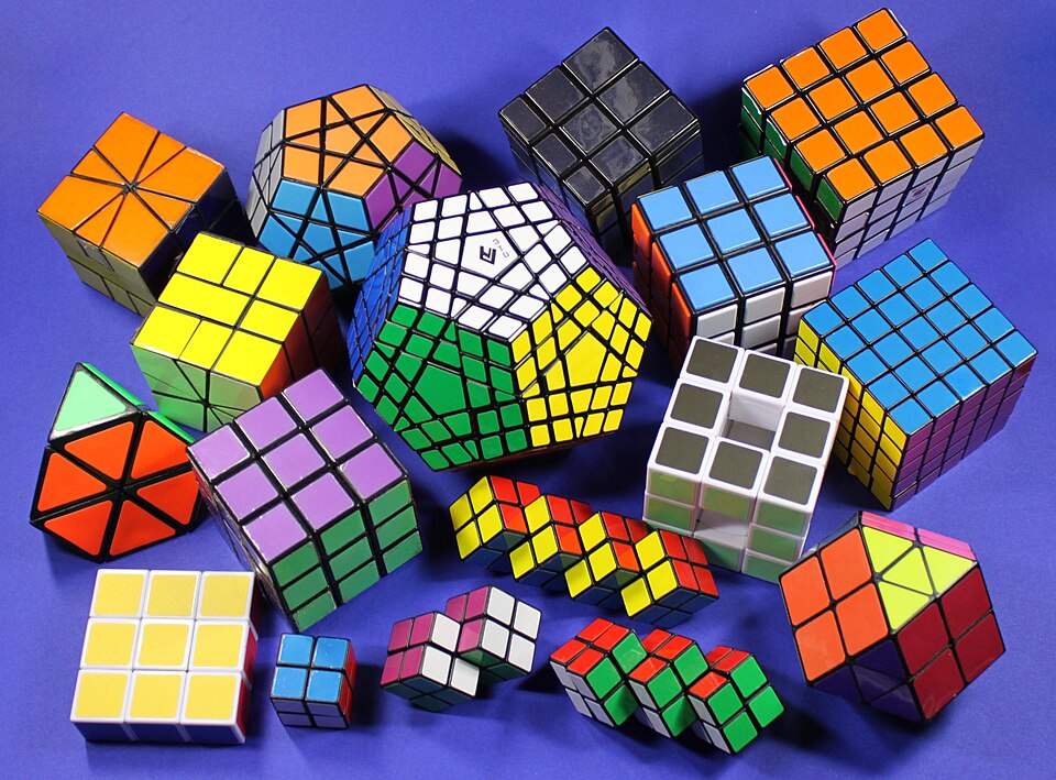 Collection of Rubik's cubes. It includes a 3x3x3, Mirror cube, Void cube, 4x4x4, 5x5x5, Megaminx, Gigaminx, Square-1, and a 2x2x2, etc.