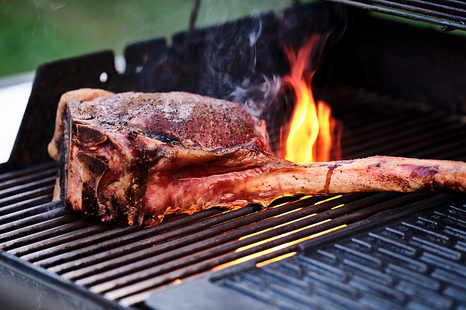 Beef steaks on a grill.