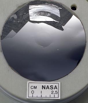 A thin cut of a large crystal of silicon that is very smooth. This is the type of silicon can be used in computers because it is very pure.