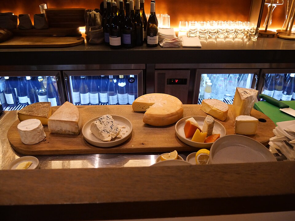 Some cheeses on the wood board
