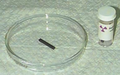 A small amount of uranium in a glass dish