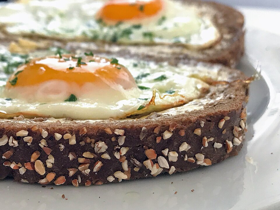 Whole grain bread served with butter and eggs